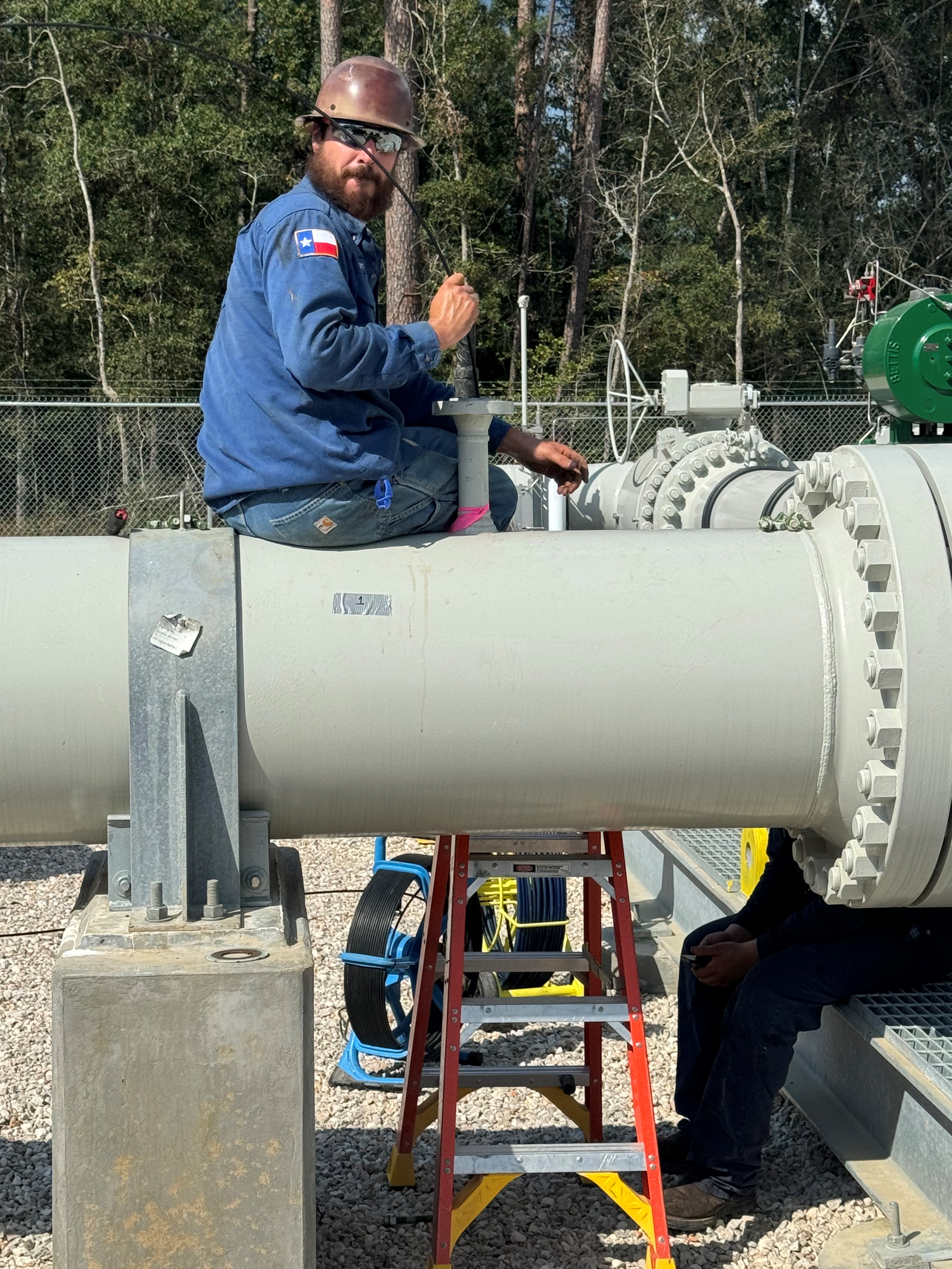 Clean-Co worker using an explosion proof camera on a gas line