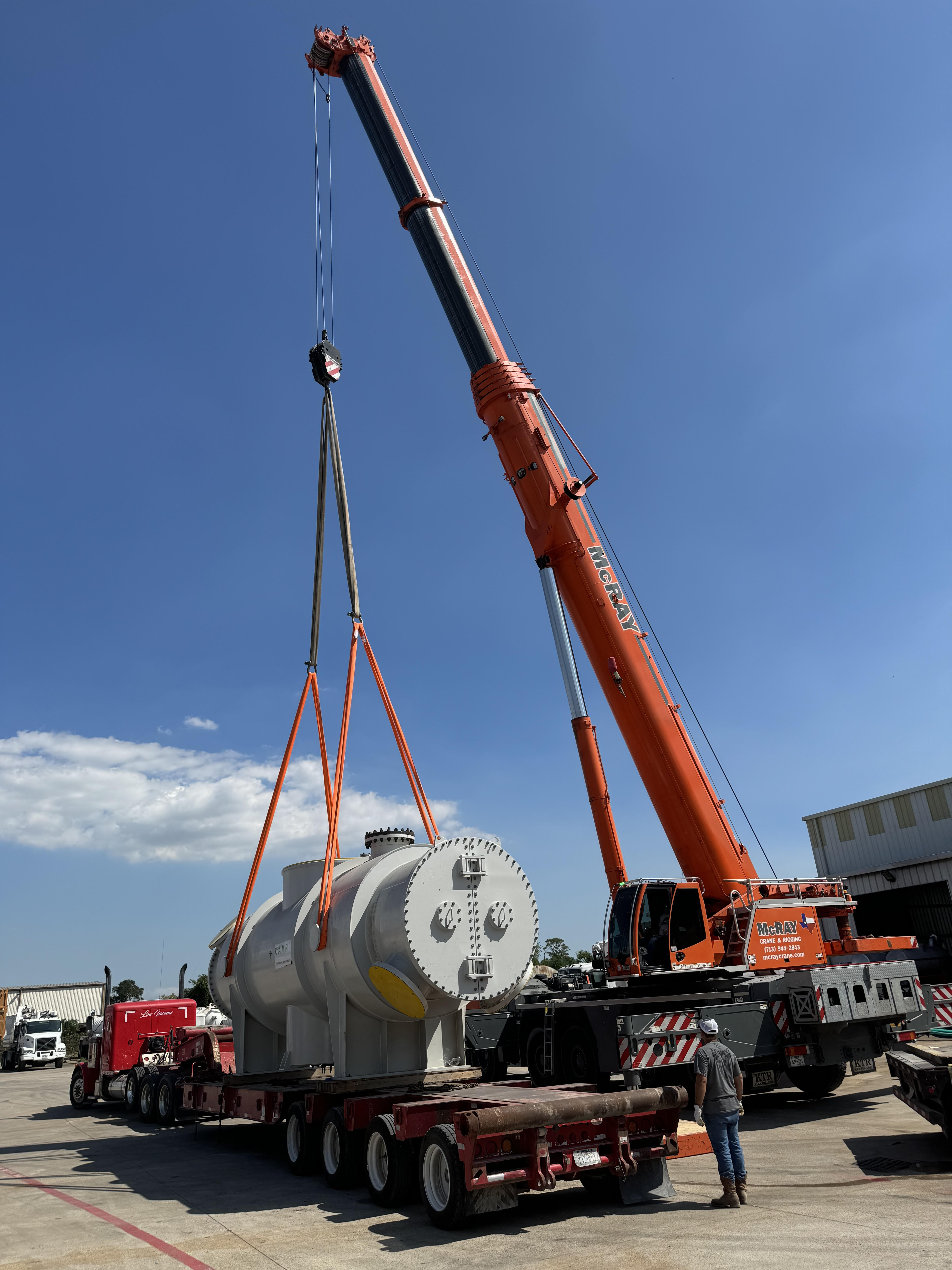 Crane hoisting a heat exchanger to be cleaned